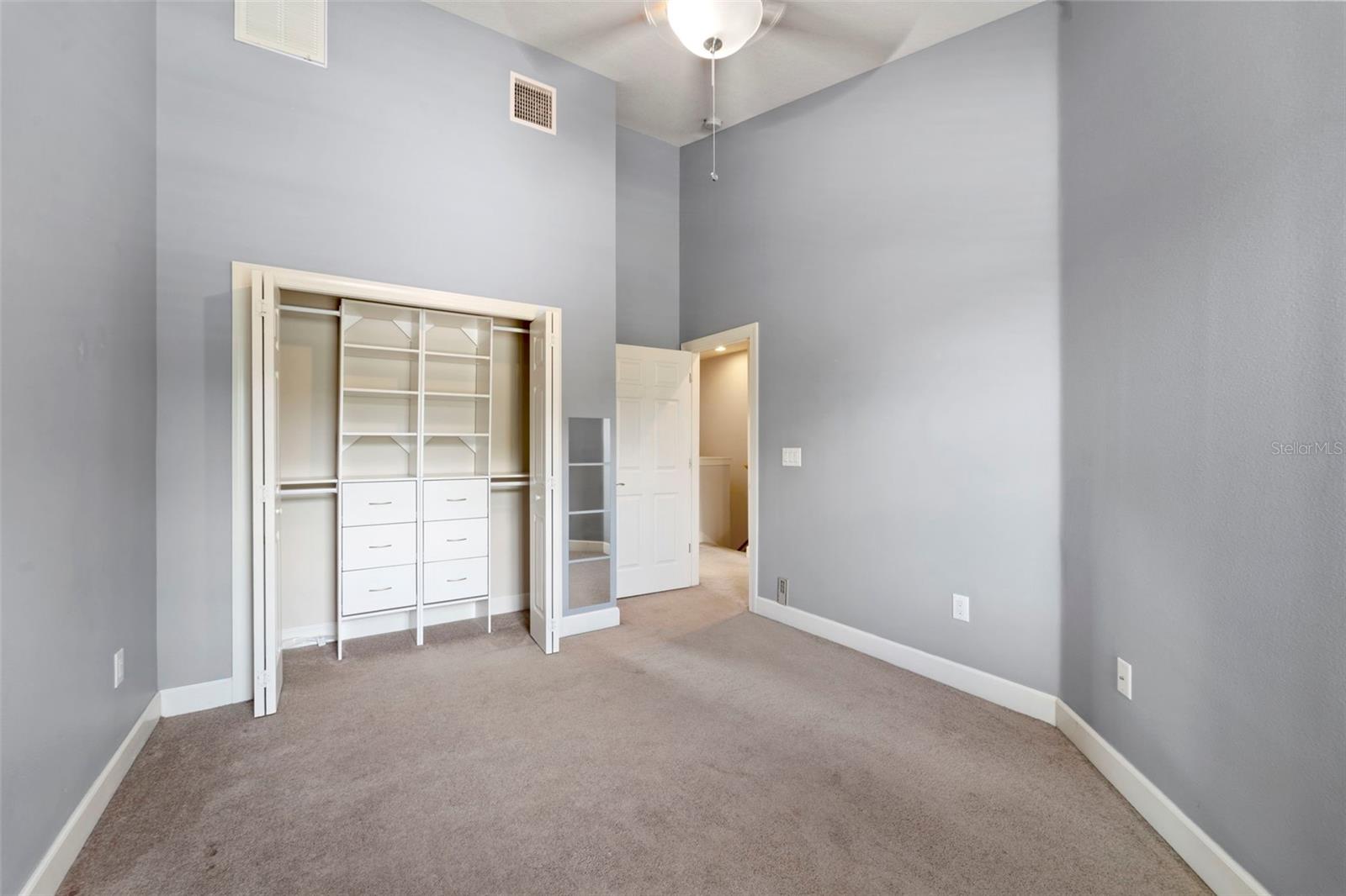 Custom built closet in guest bedroom