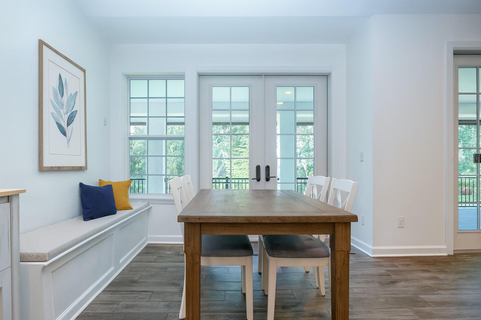 STAGED VIEW OF BREAKFAST NOOK AND FRENCH DOORS