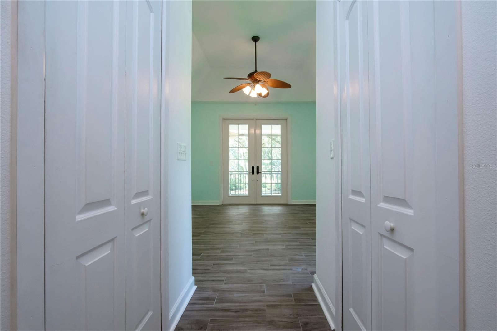 VIEW OF THE PRIMARY BEDROOM AND HIS AND HERS WALK IN CLOSETS