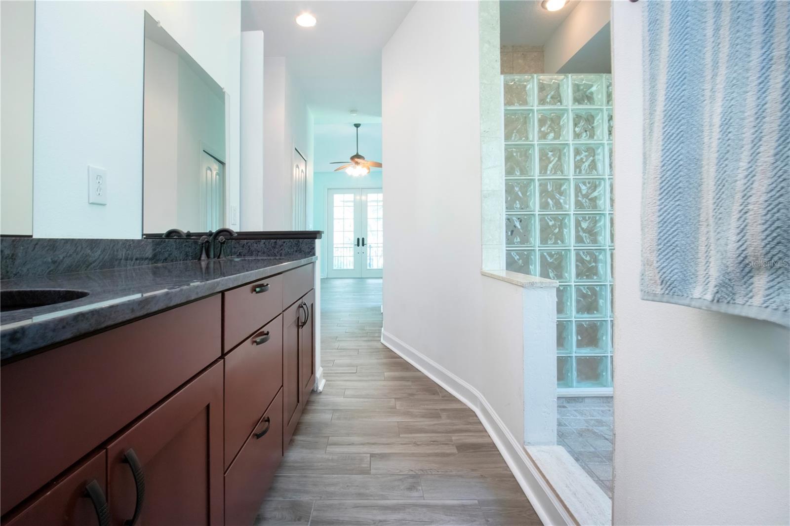 PRIMARY SHOWER AND VANITY FROM THE WATER CLOSET