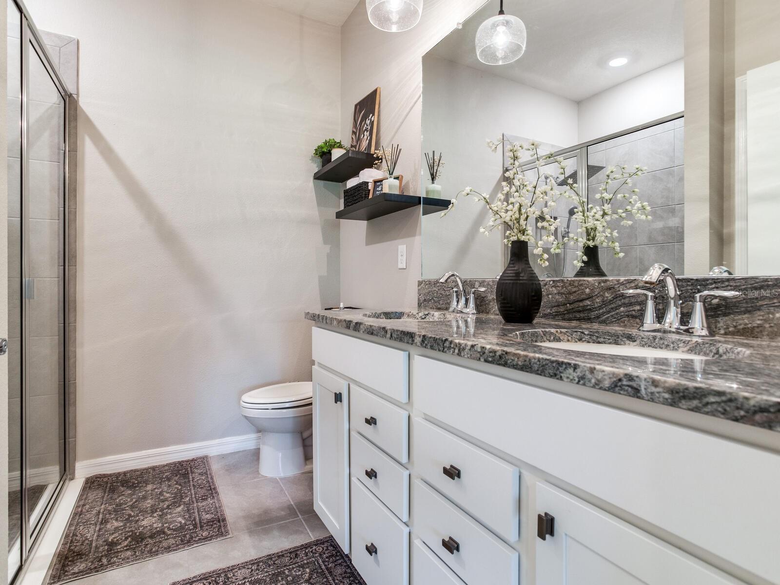 Master bathroom with beautiful granite and large shower with rain showerhead