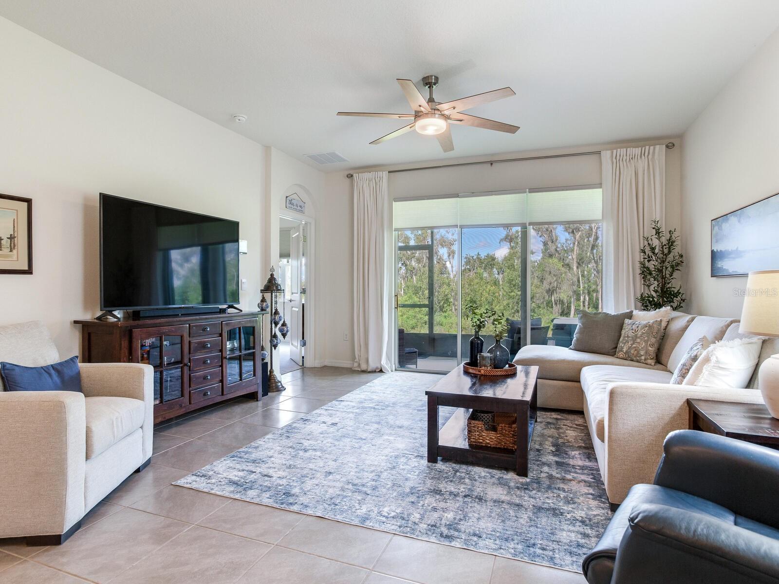 Livingroom looking through lanai to conservation area