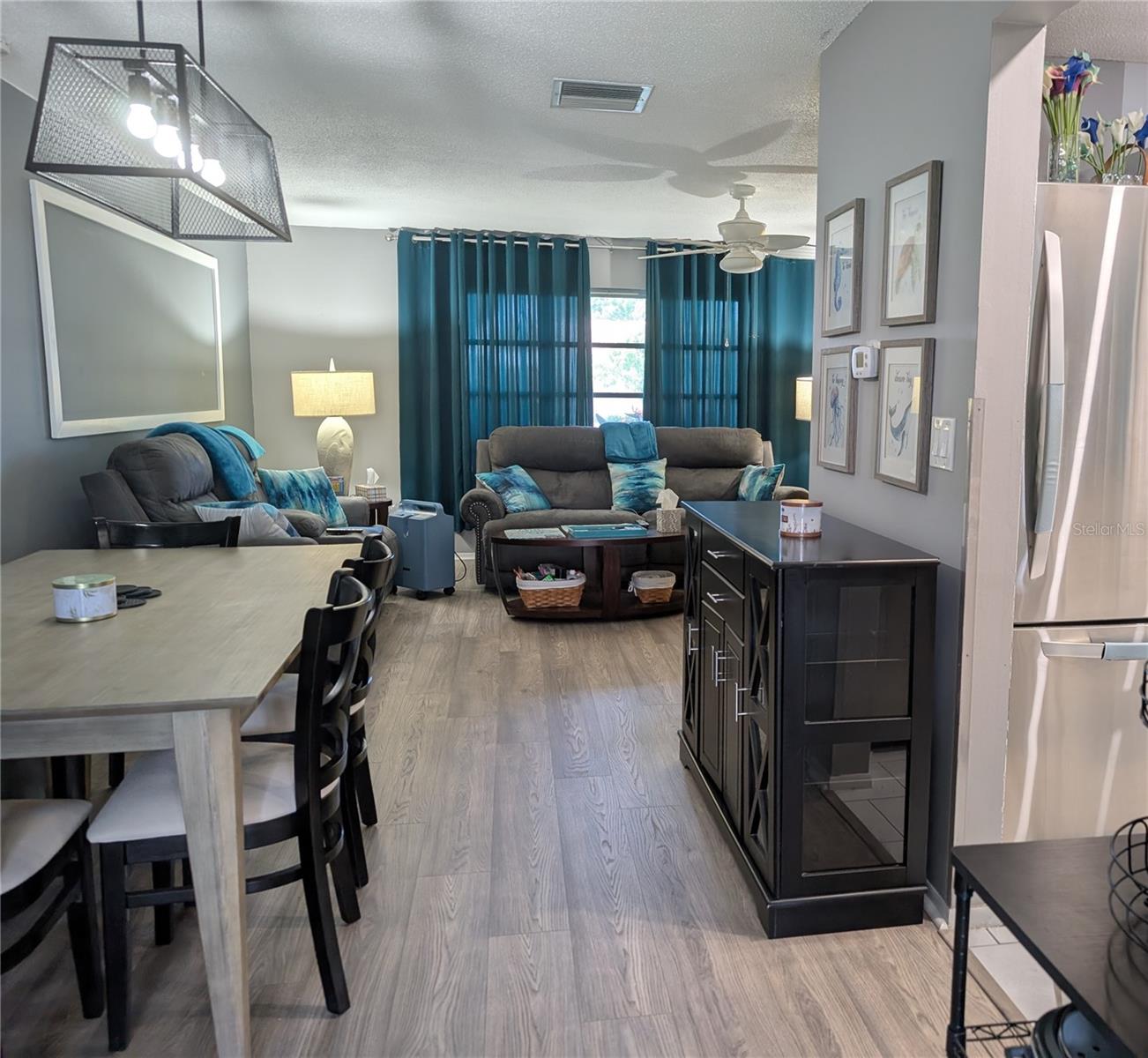 View of dining area into living area from Florida room.  Kitchen to right.