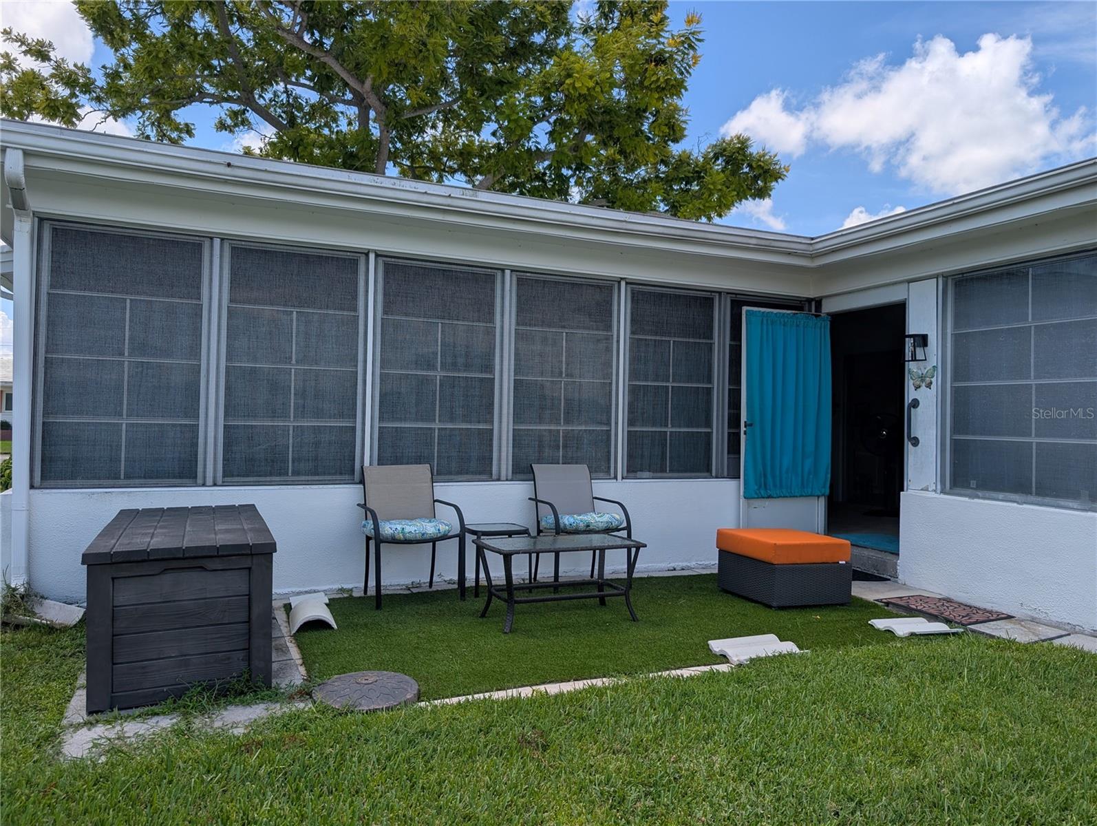 View of back patio into Florida room.  This area could also be used to expand the Florida room or install a screened back patio room.