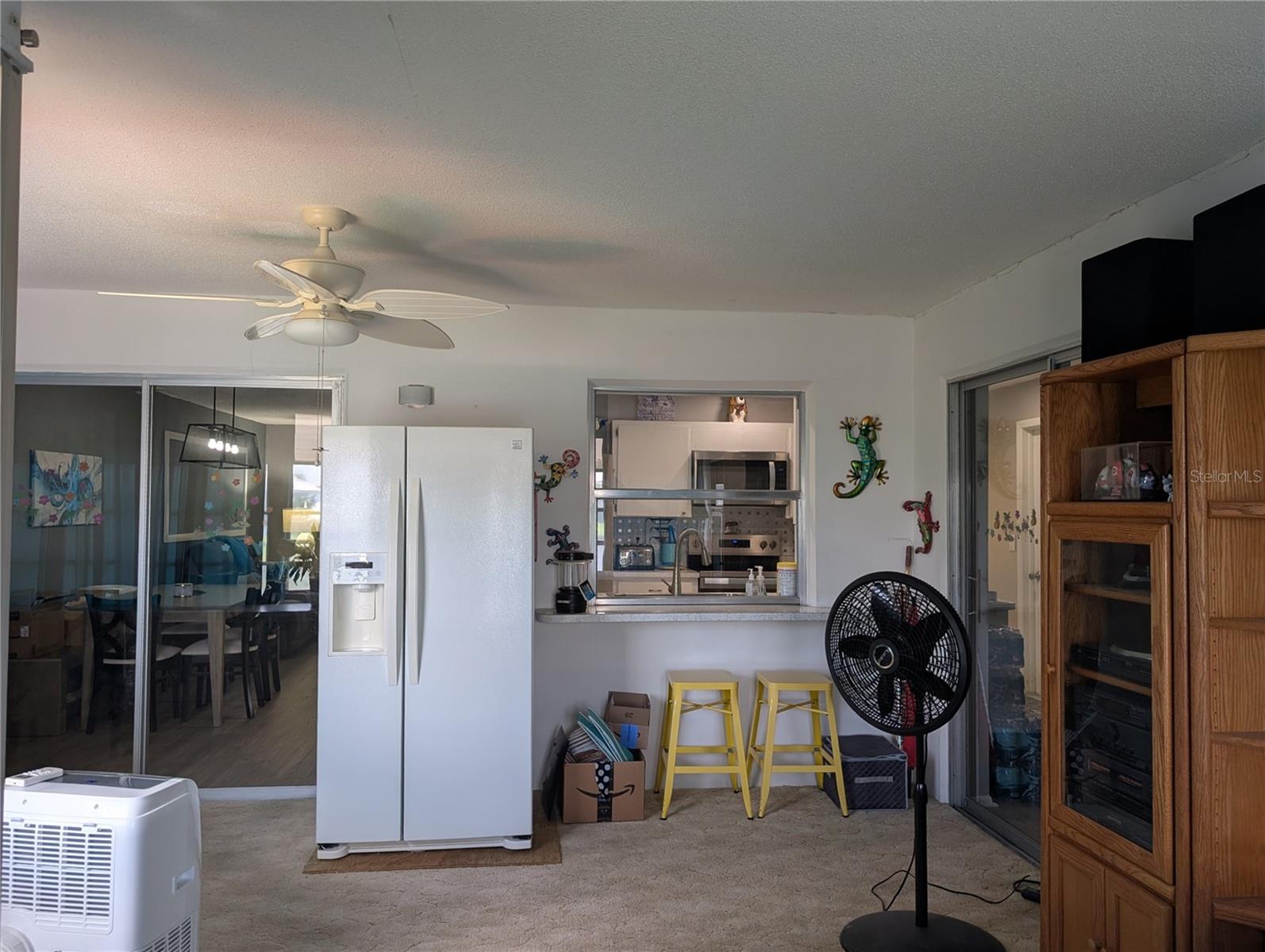 View from Florida room into dining room and kitchen.  Bonus area and guest suite to right.