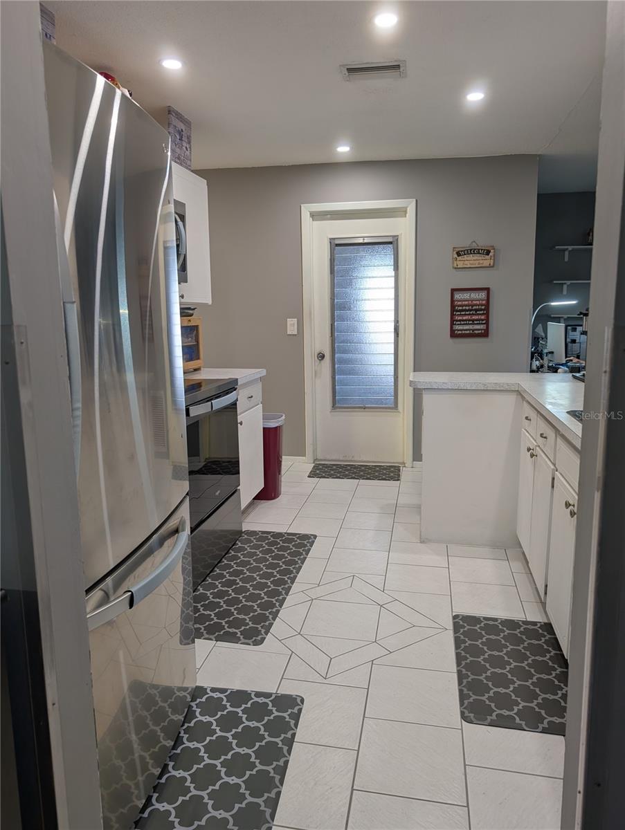 Kitchen view to Garage access leading to Laundry area.