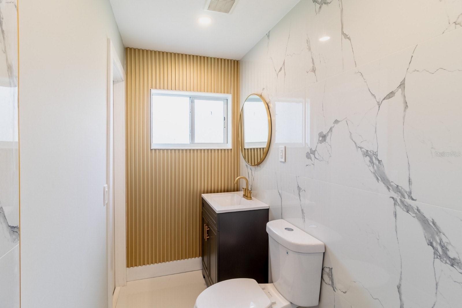 Fluted wood wall in owner bath suite