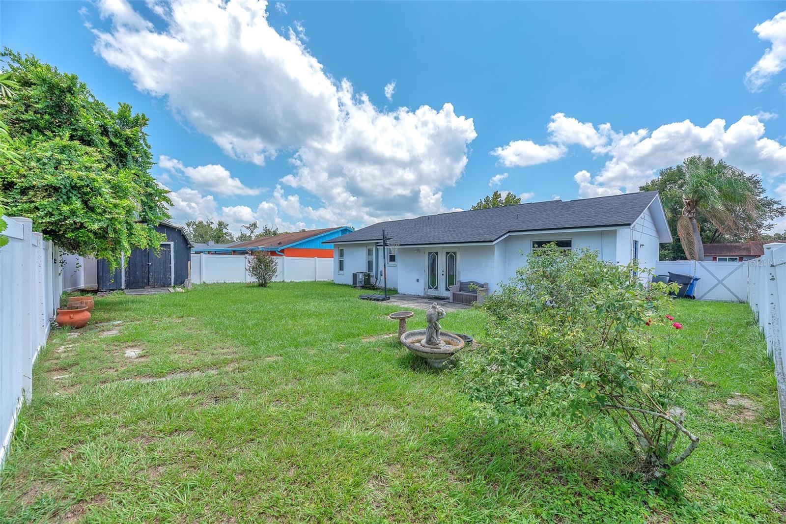 Spacious backyard with storage shed for you toys and lawn equipment.