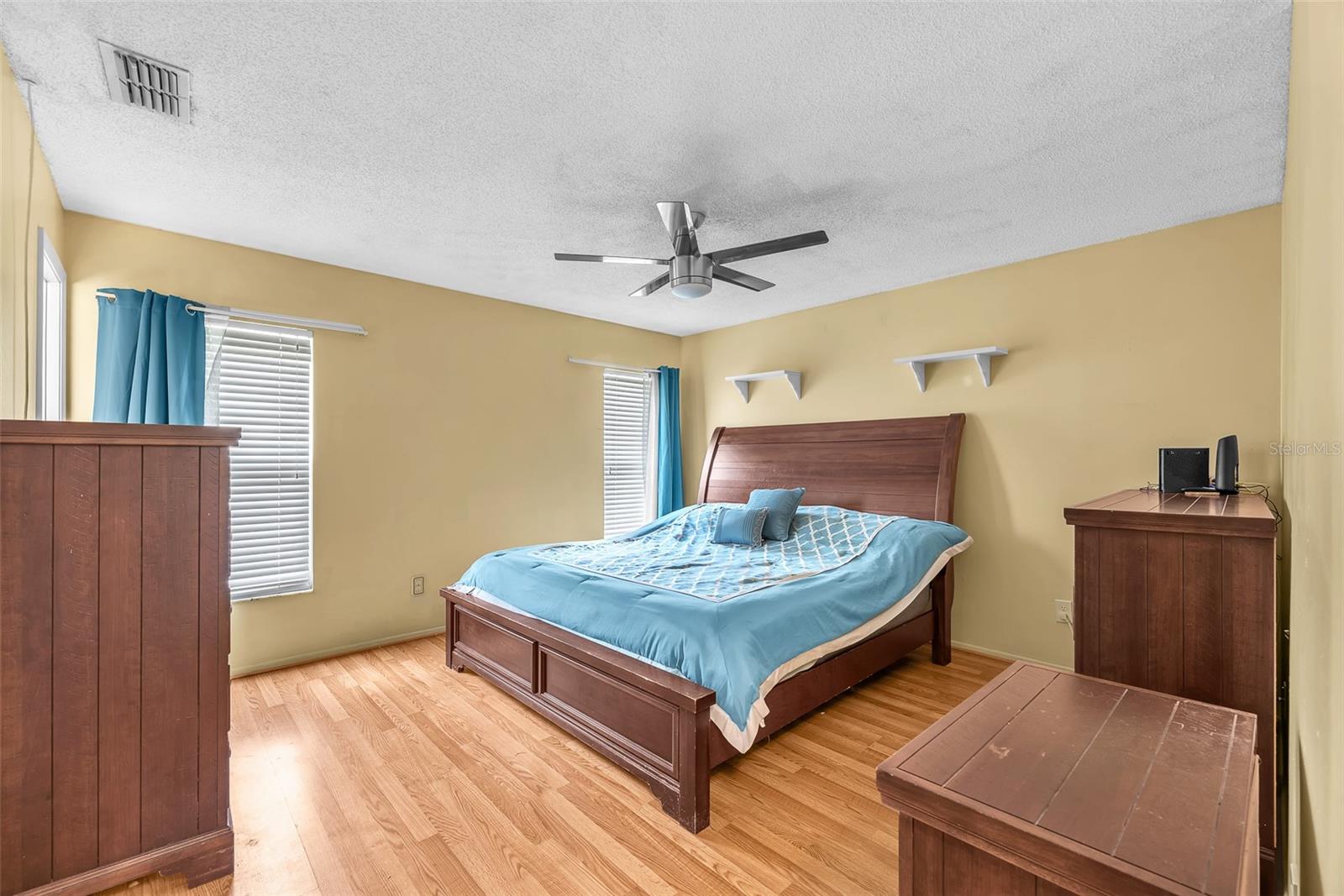 The primary bedroom includes an en-suite bath with a walk-in shower, offering both privacy and functionality.