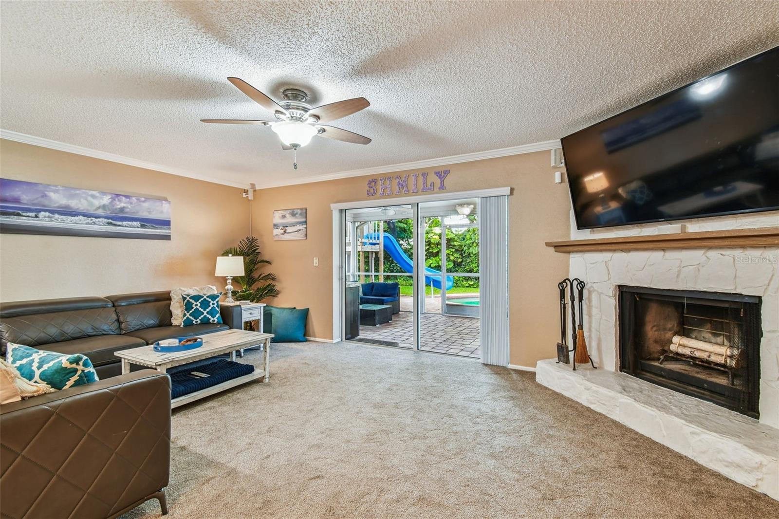 Spacious living room leads to enclosed patio