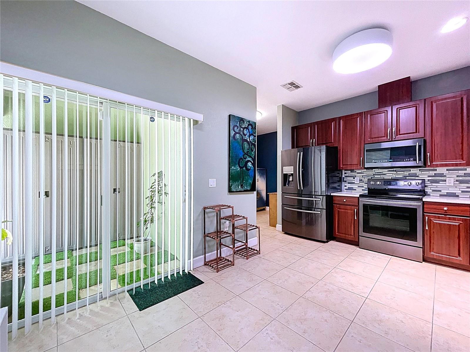 view of sliders to patio from kitchen
