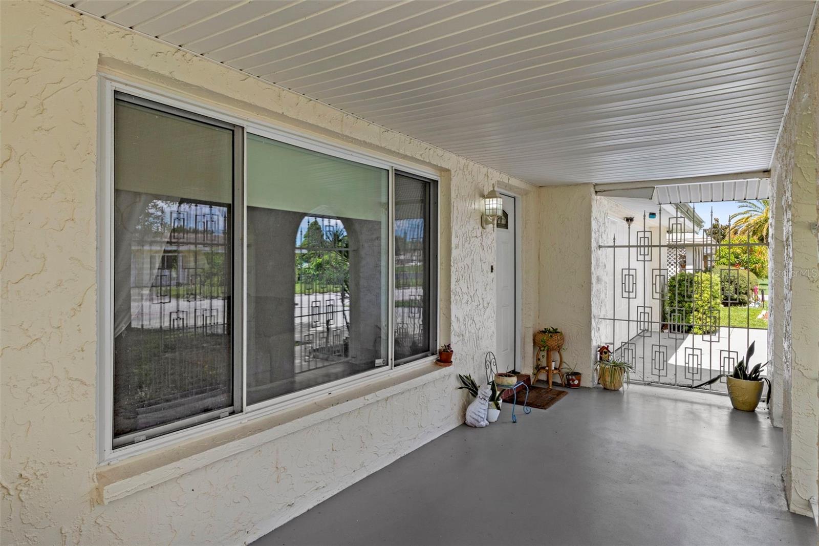 Beautiful screened front porch-nicely shaded.