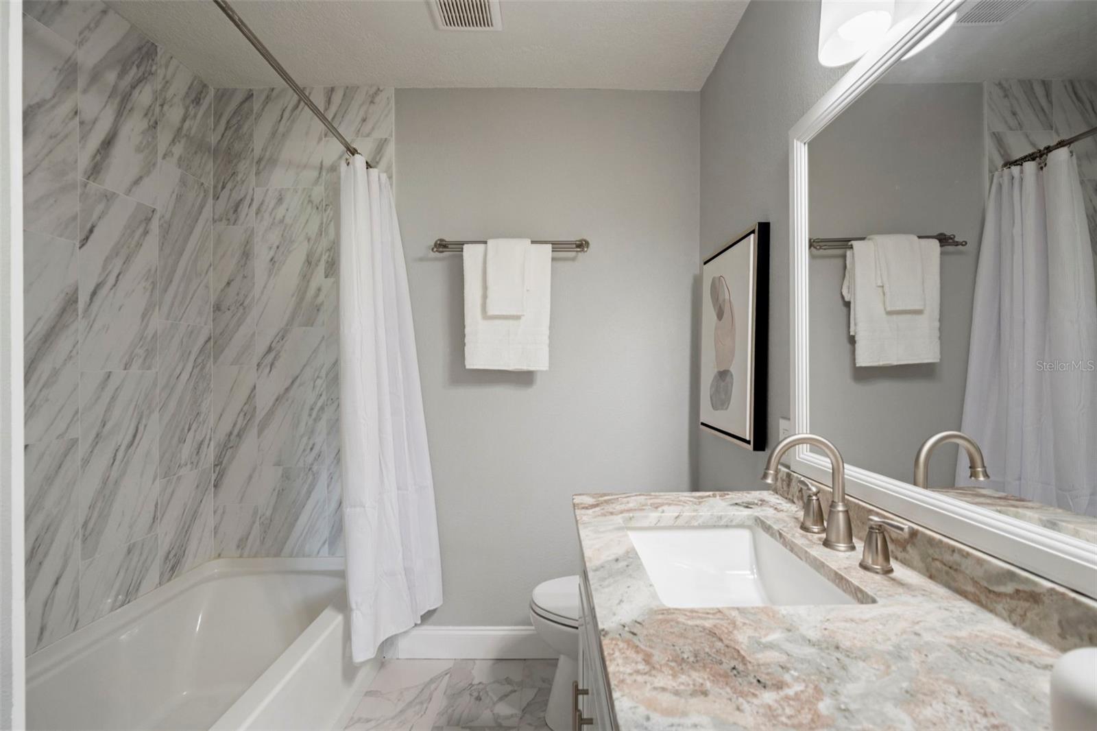 Hallway Bathroom that shares Primary Bedroom and Second Bedroom