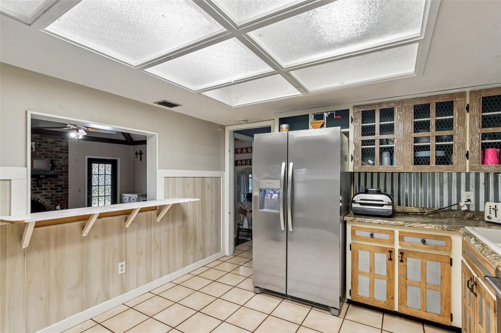 Kitchen with pass through to Family Rroom and Hallway entry