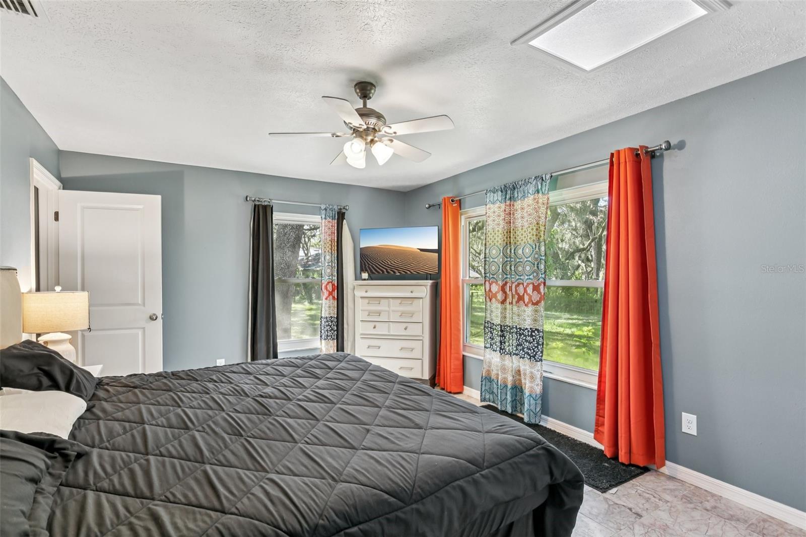 Primary Bedroom with natural light and ensuite bathroom