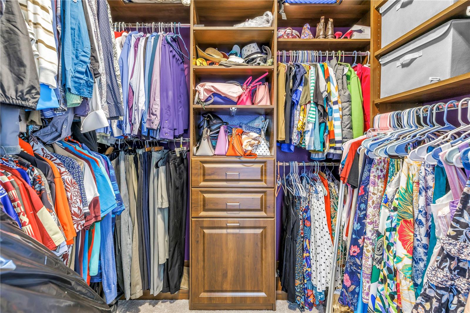 Walk-in closet w/ custom closets by Closets by Design
