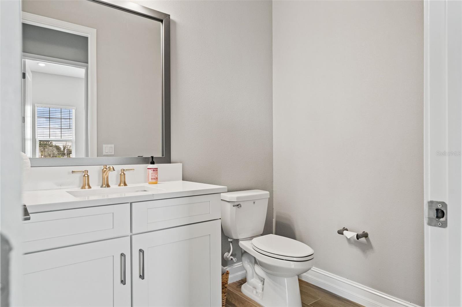 Downstairs half bath adjacent to bedroom 2
