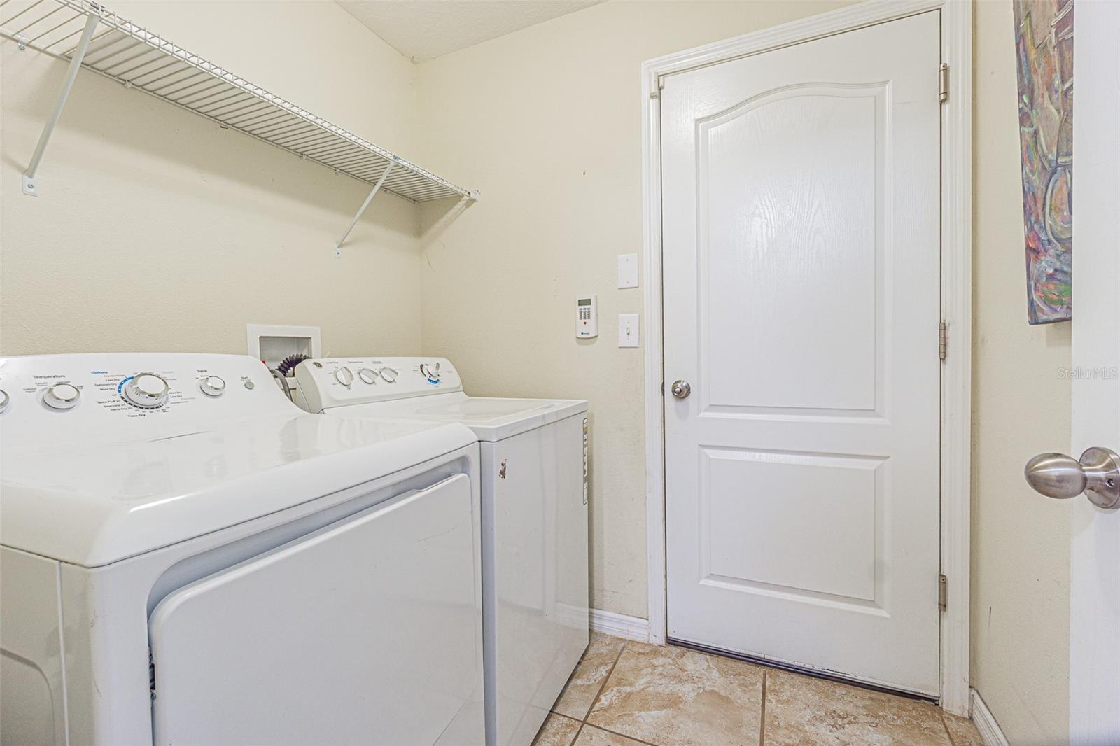 The laundry room is at the end of the hall and exits to the 2-car garage.