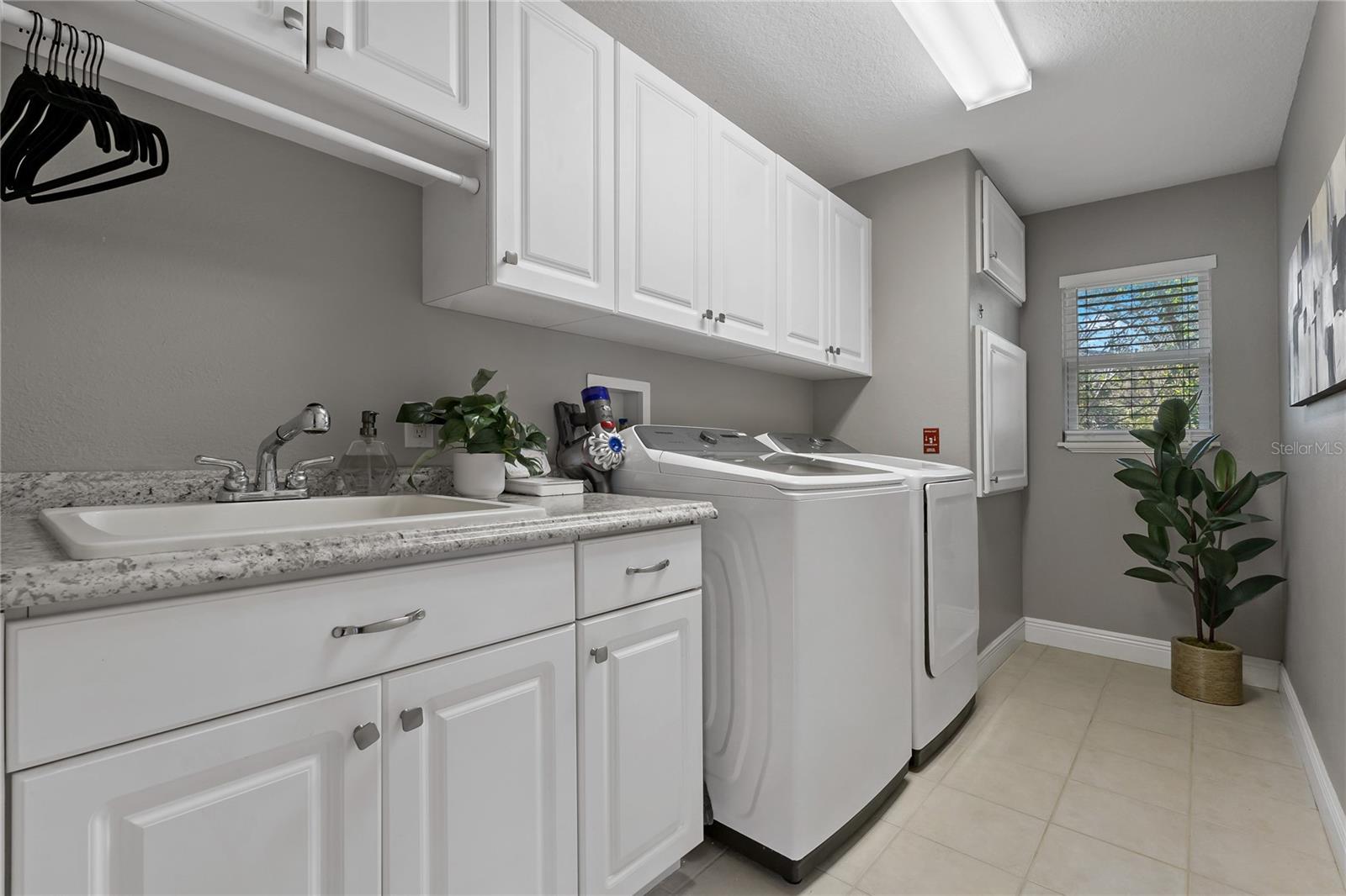 LAUNDRY ROOM WITH DUMBWAITER ENTRY COMING UP FROM THE GARAGE