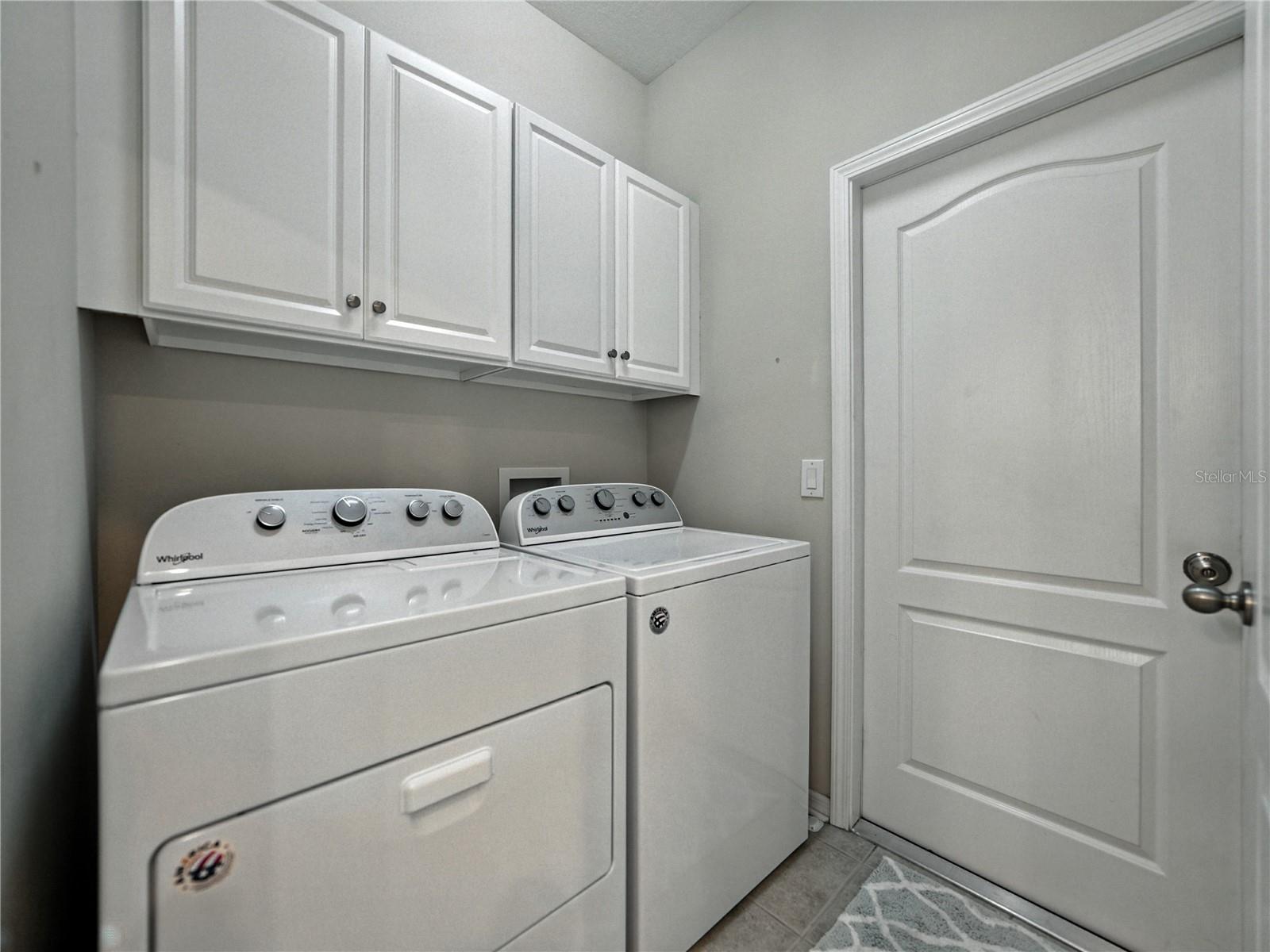 Laundry room with access to garage.