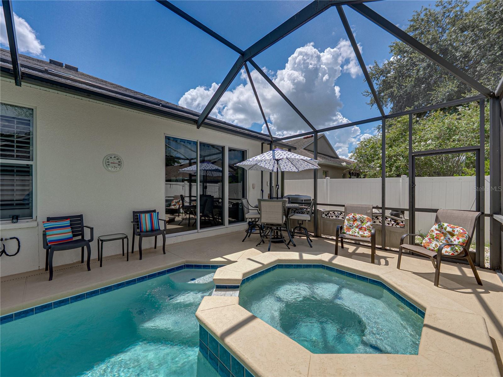 Screened-in pool with spa