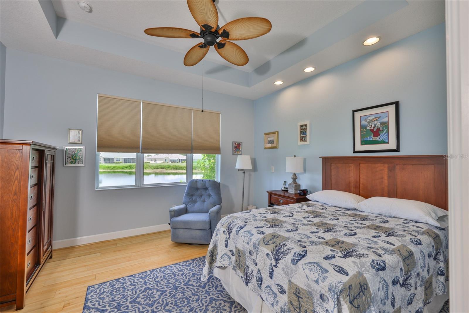 Primary Bedroom, tray ceiling, ceiling fan, laminate flooring, waterfront view