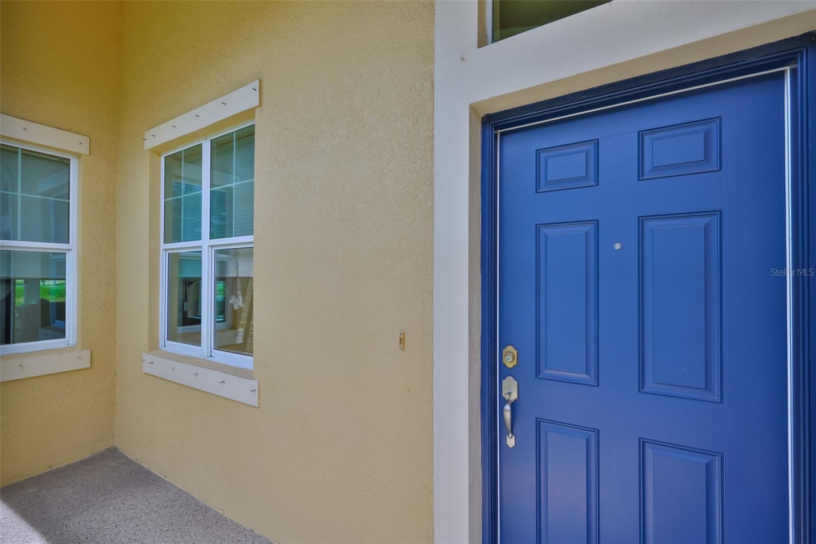 Covered and screened front door and patio