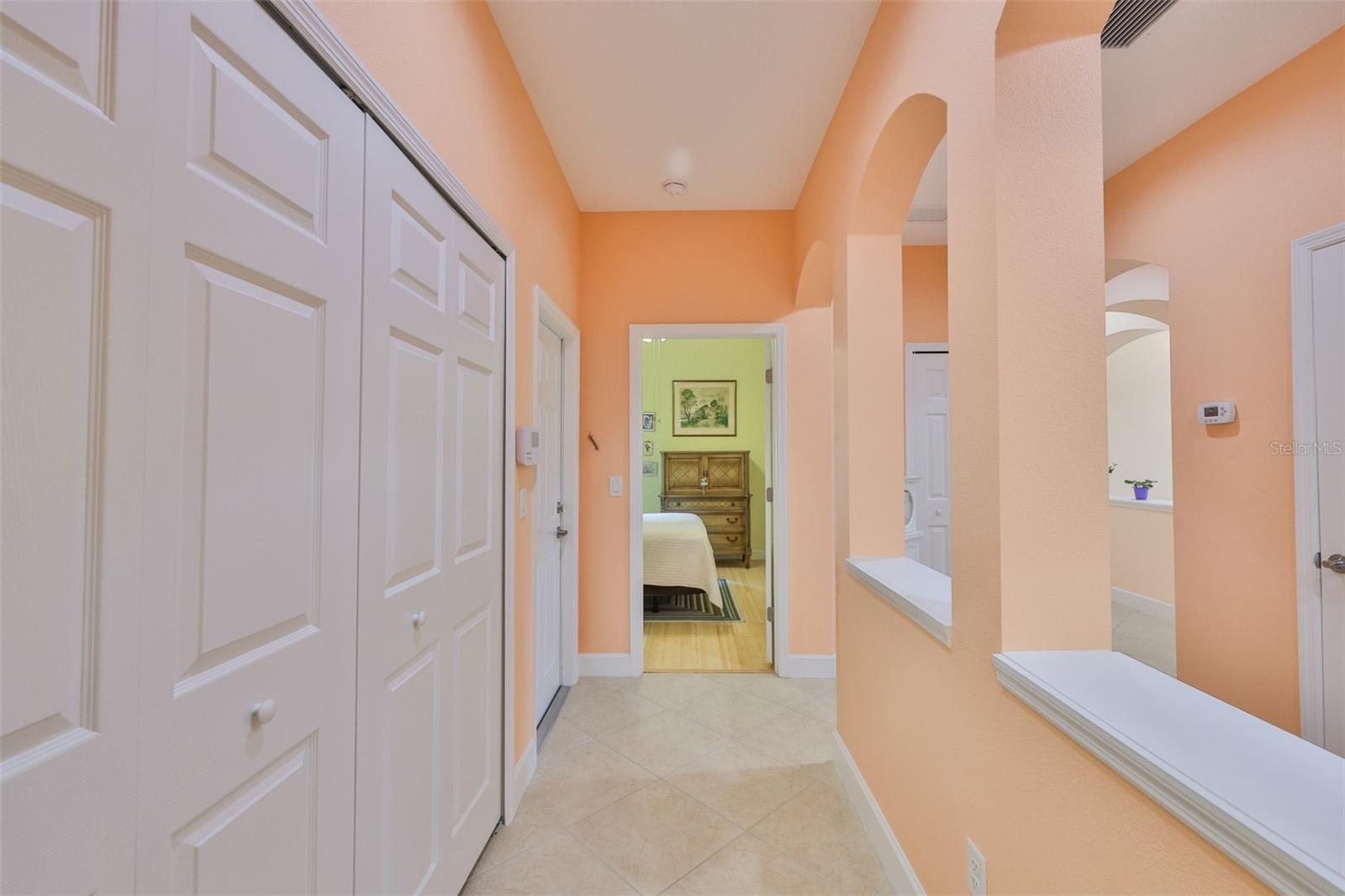 Laundry closet on left, garage door on far left, center Bedroom 2, right office/den