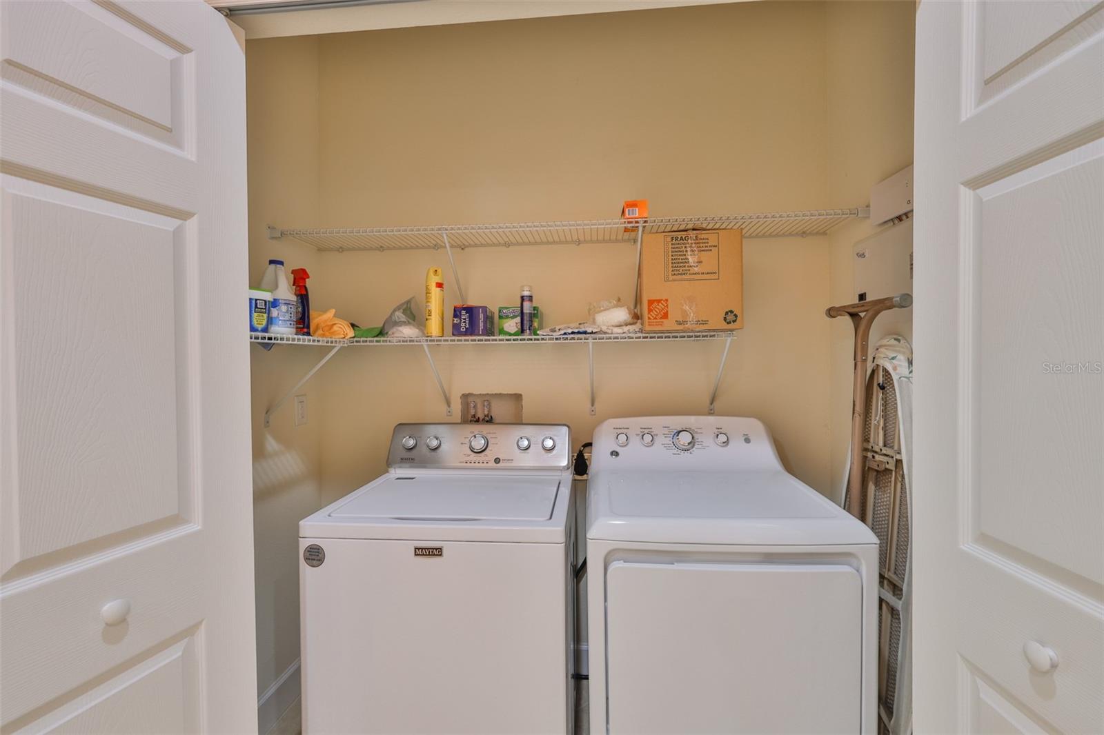 Laundry closet with washer, dryer and storage rack