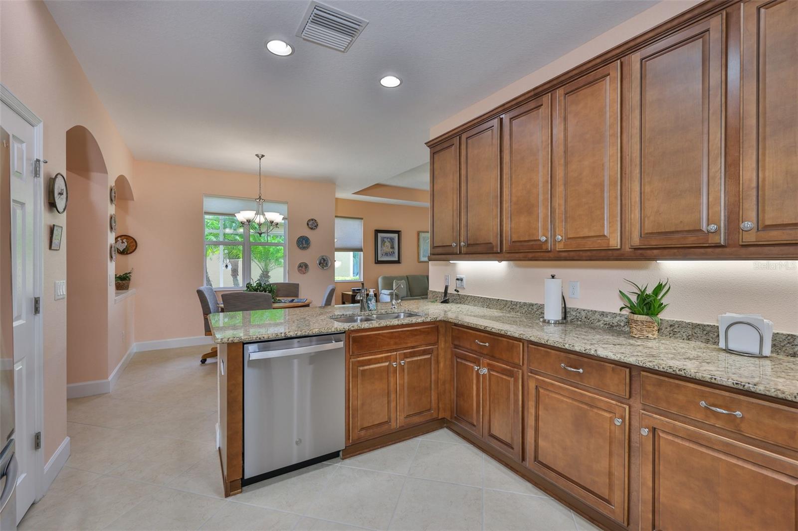 Chef's Kitchen, recessed lighting, under cabinet lighting, 42" cabinets, crown molding, closet pantry, stainless dishwasher, granite, dual stainless sinks and faucet - right view