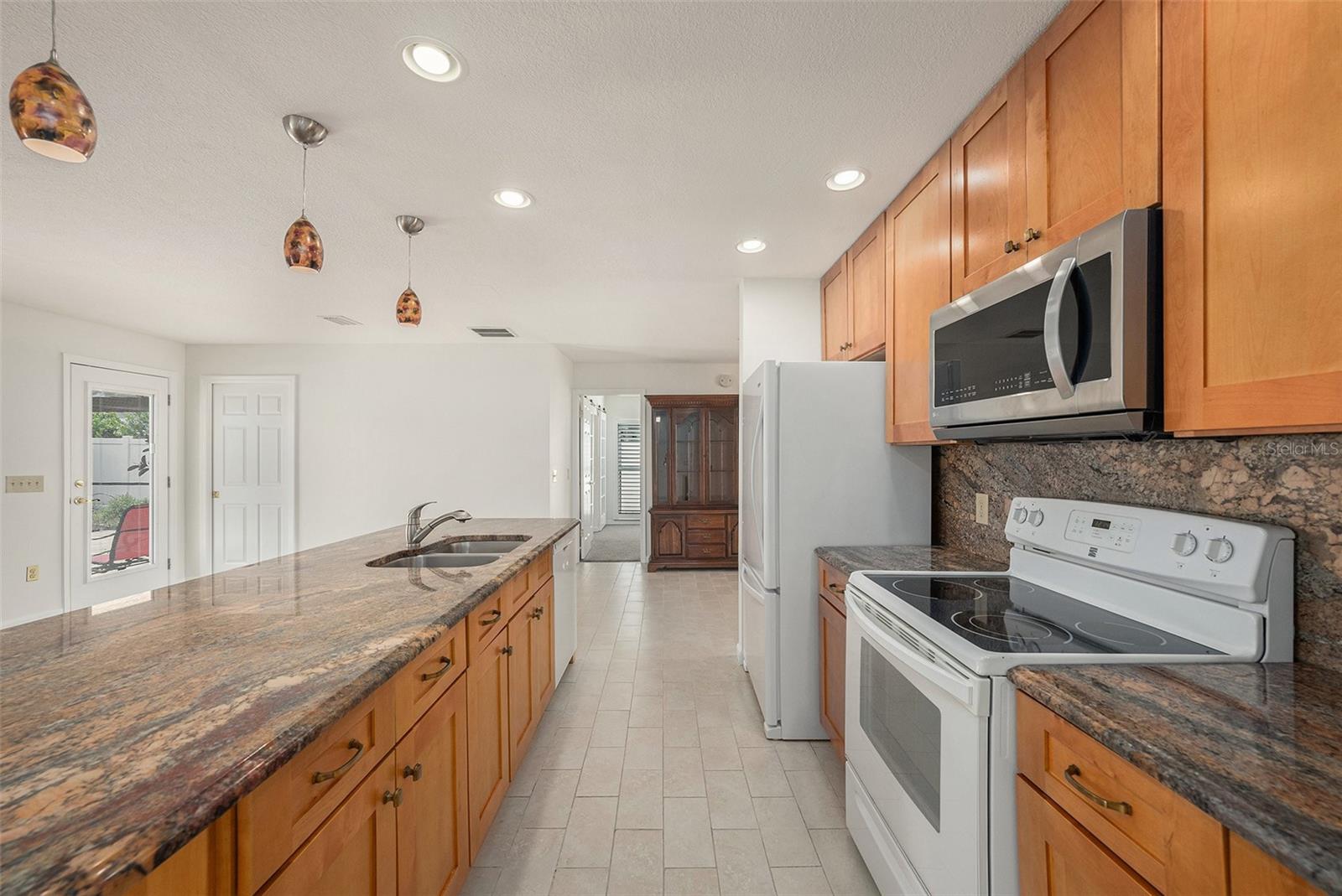 Well appointed kitchen with endless granite counters & newer appliances!