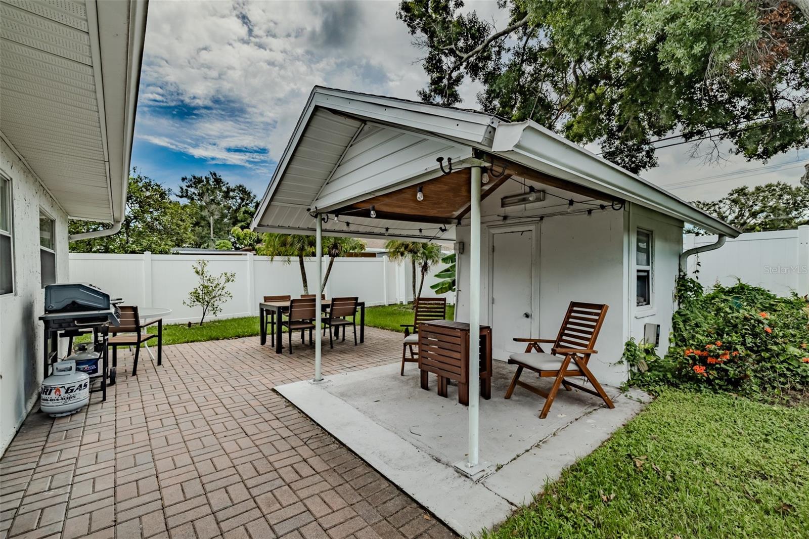 Storage building with fully fenced in paved outdoor seating