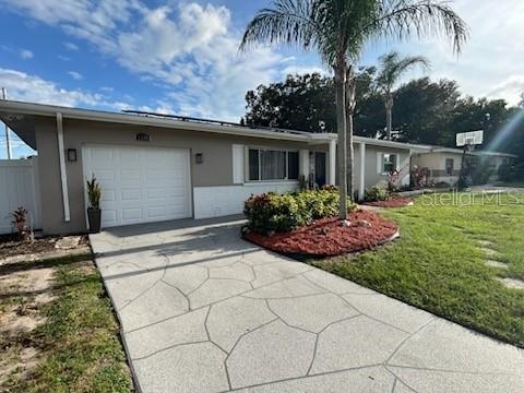 Front of house with upgraded epoxy driveway