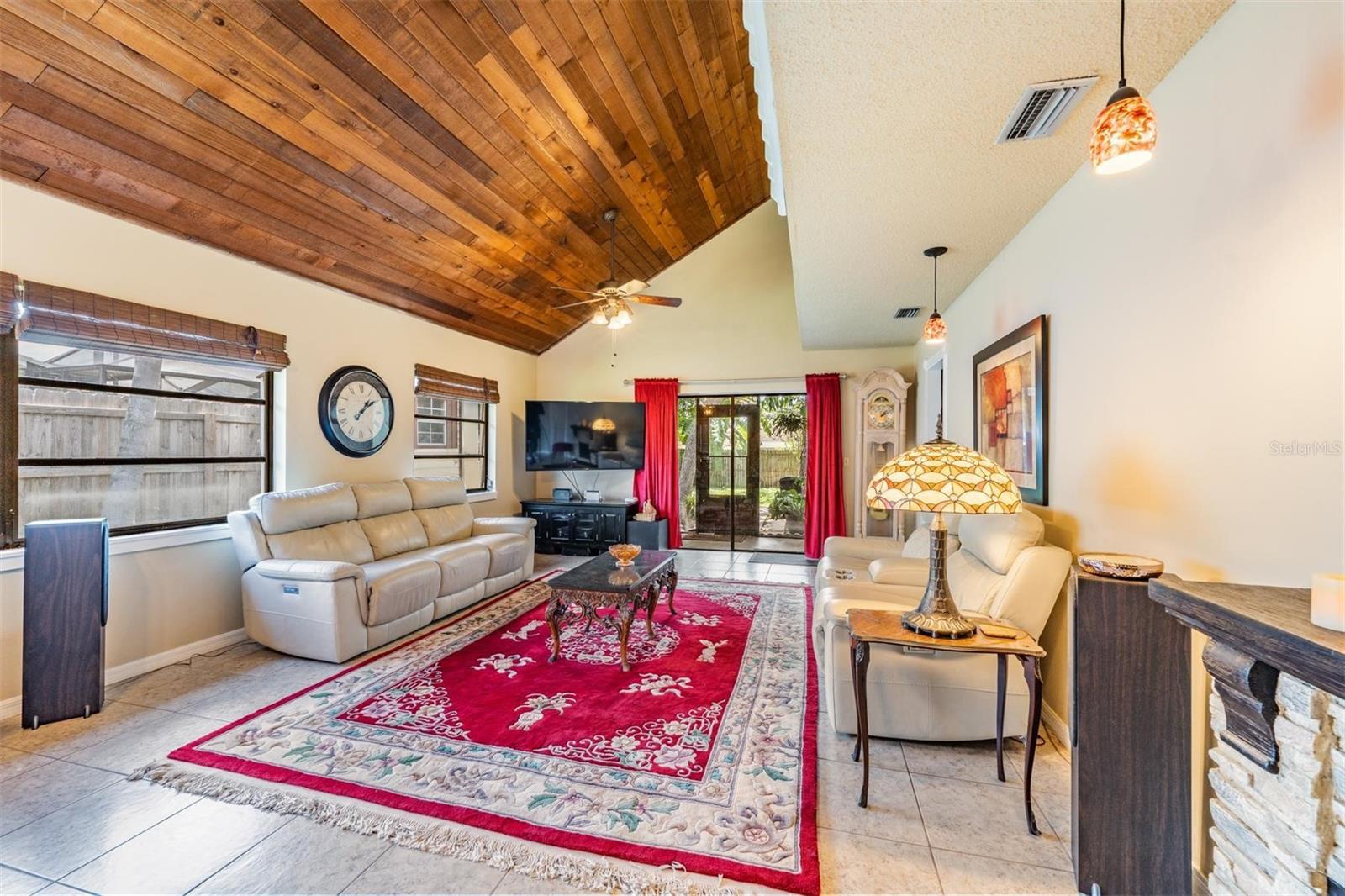 Living room w/high wood lined ceilings