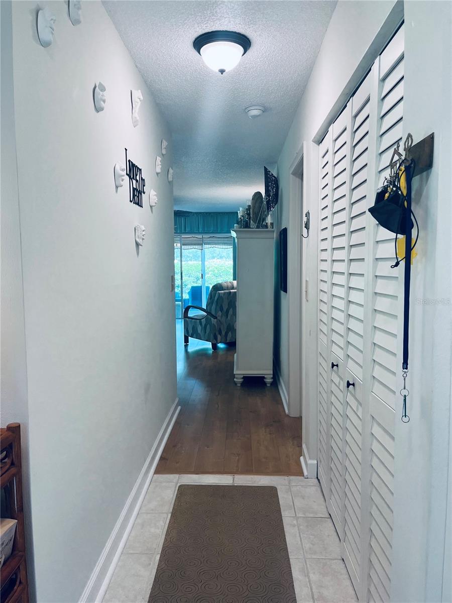 View down hallway at front entrance to LR/DR