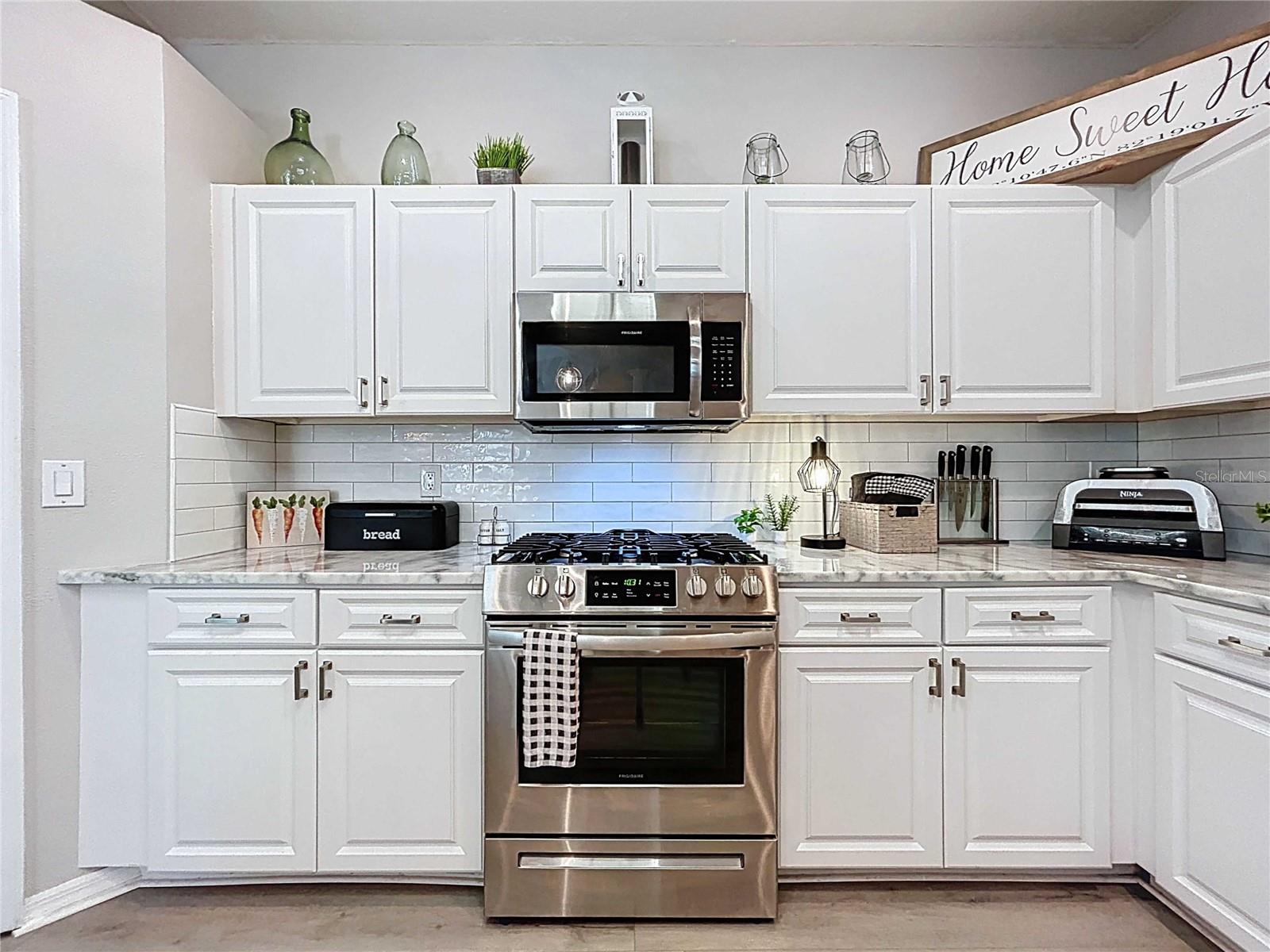 Kitchen featuring subway backsplash tile