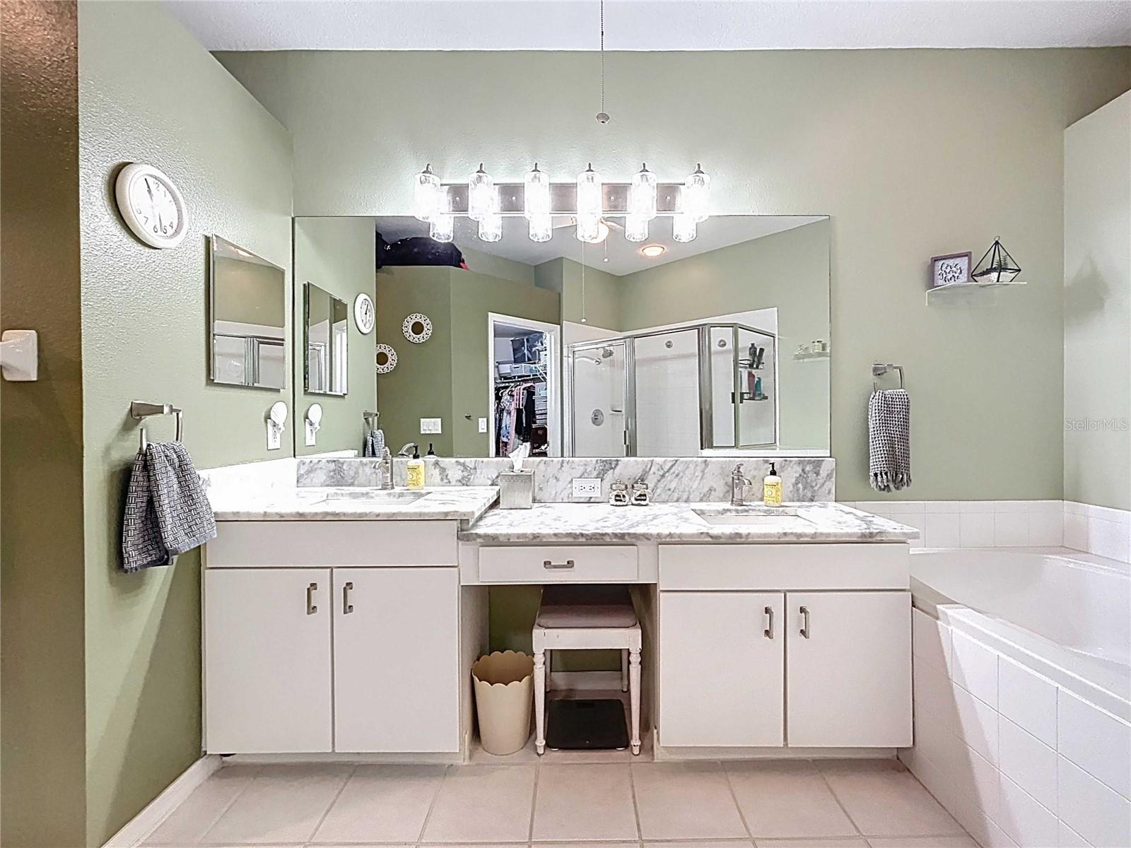 Primary bath with updated lighting & tile flooring