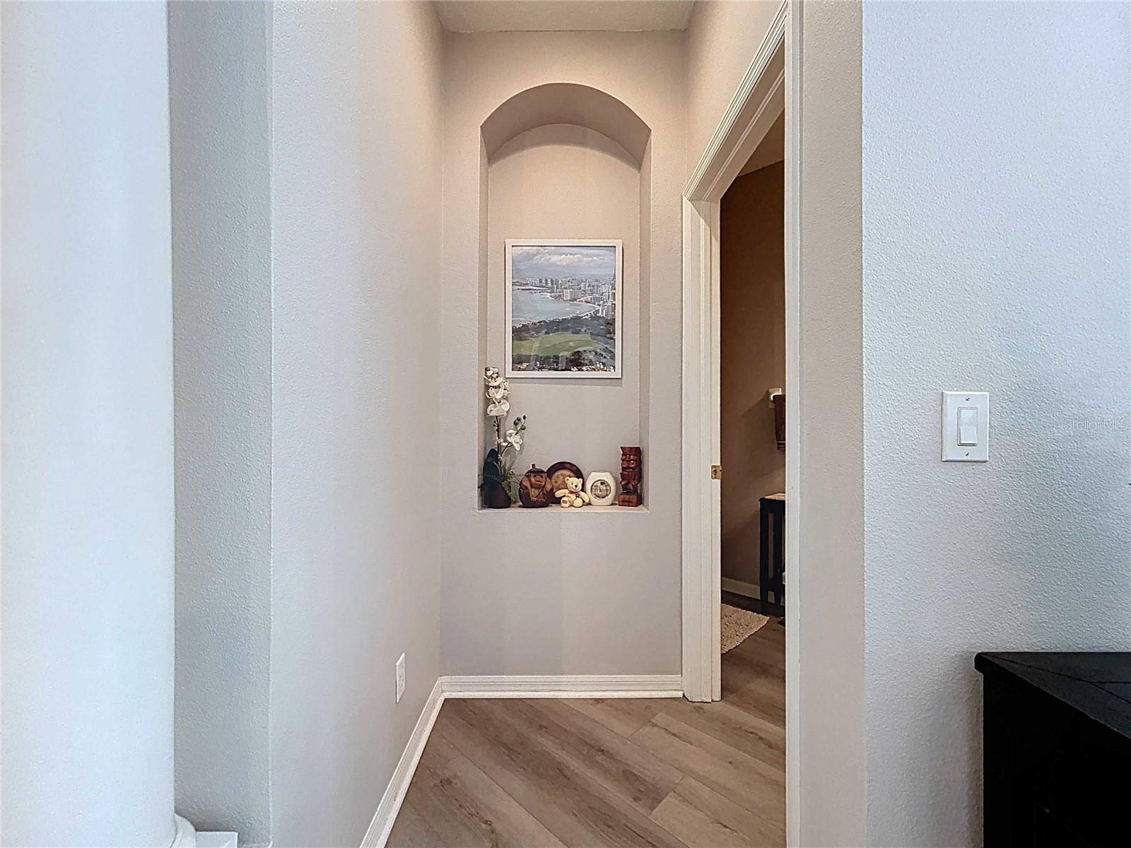 Arched niche at entrance to half bath off dining room