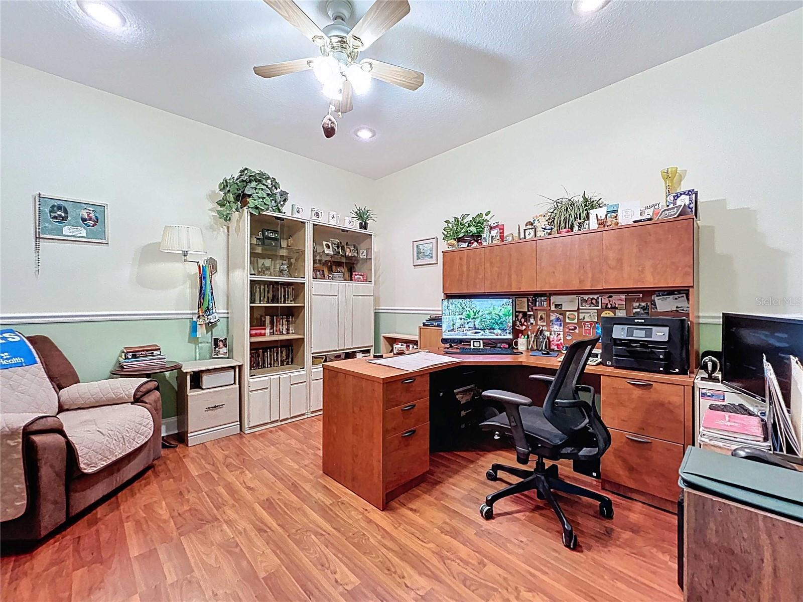 Office with chair rail and laminate flooring