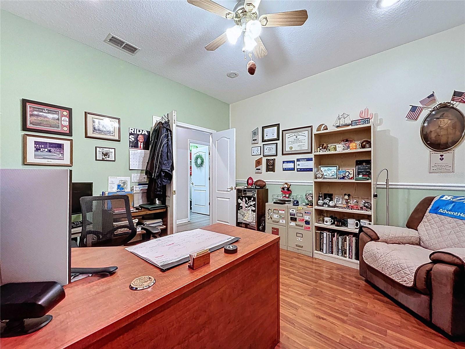 Office with chair rail and laminate flooring