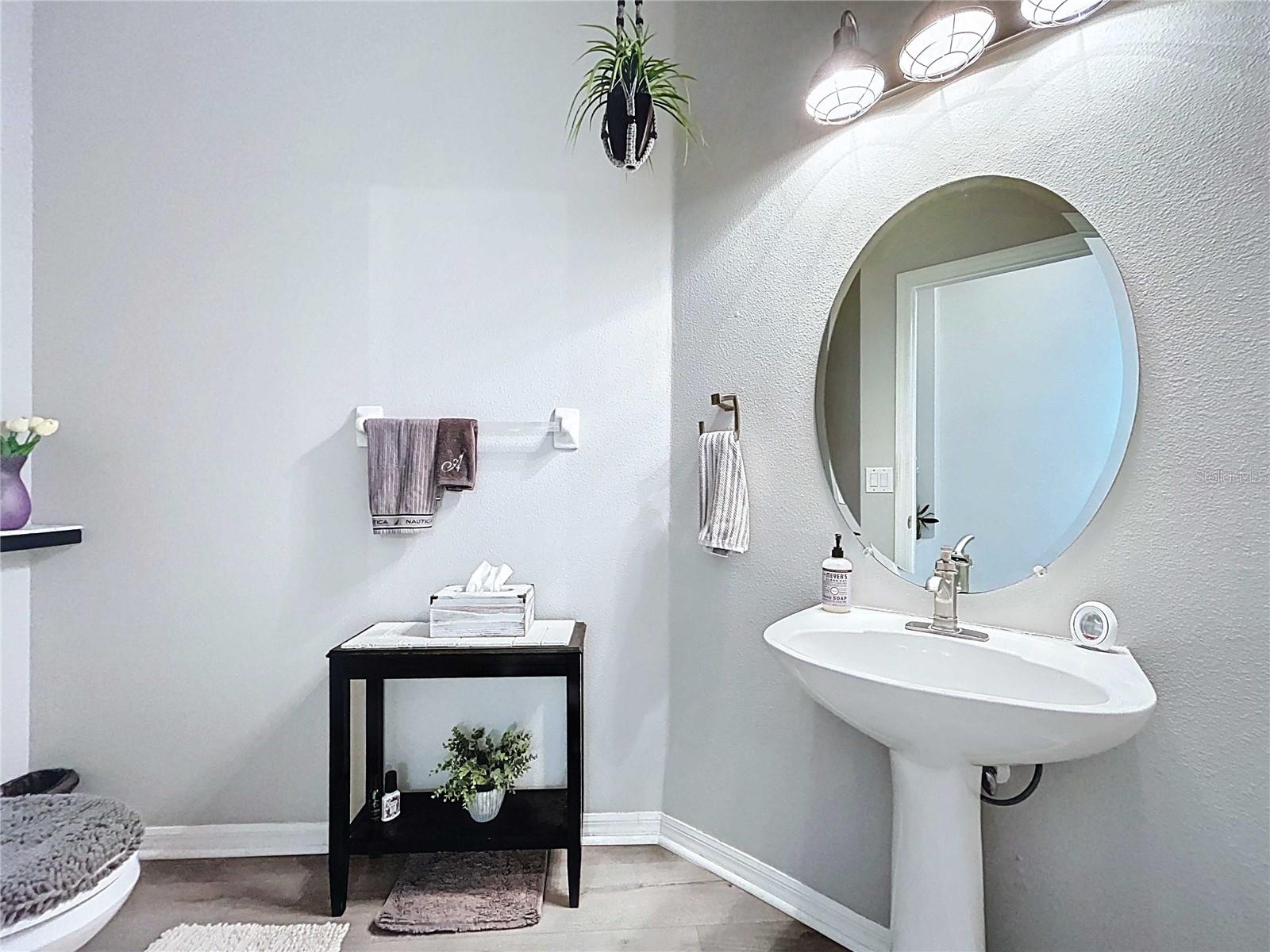 Half bath with LVP flooring & pedestal sink