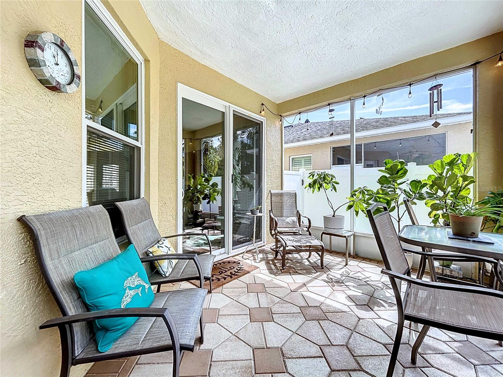 Screened-in covered lanai with paver flooring