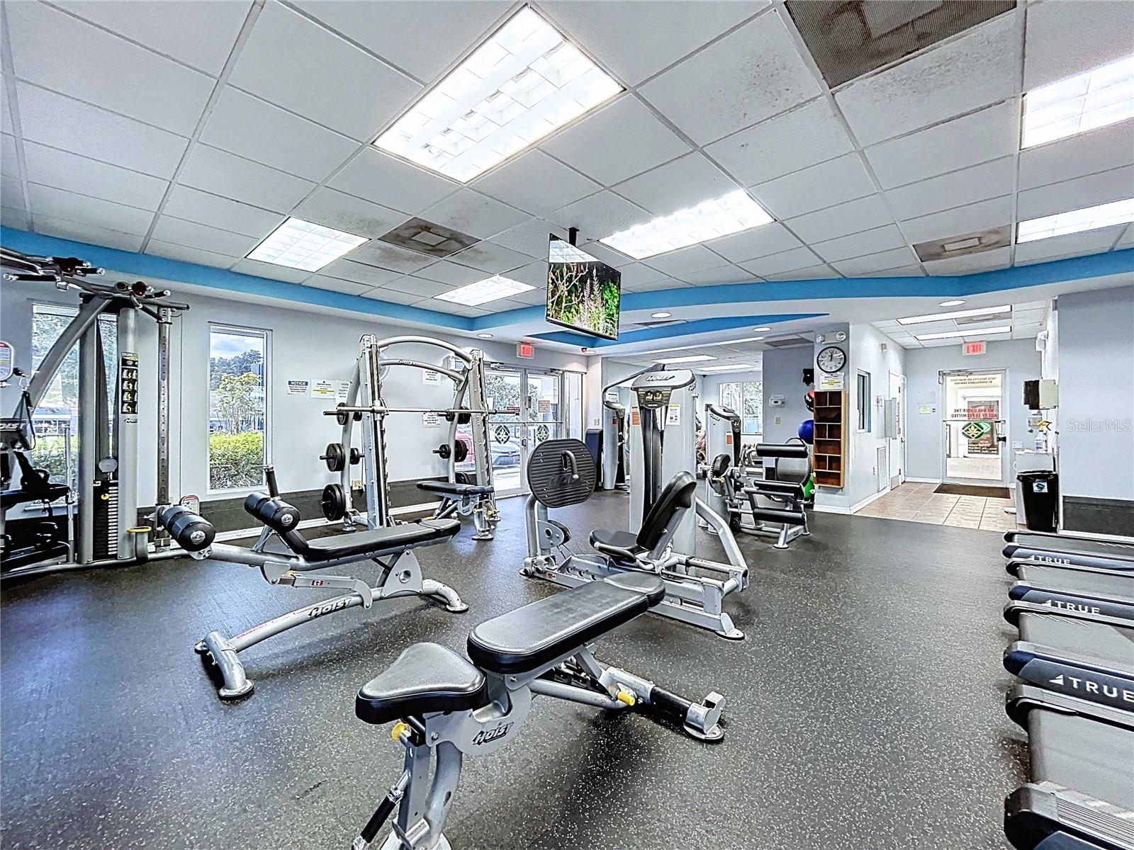 Amenity center fitness room with machines & aerobic equipment