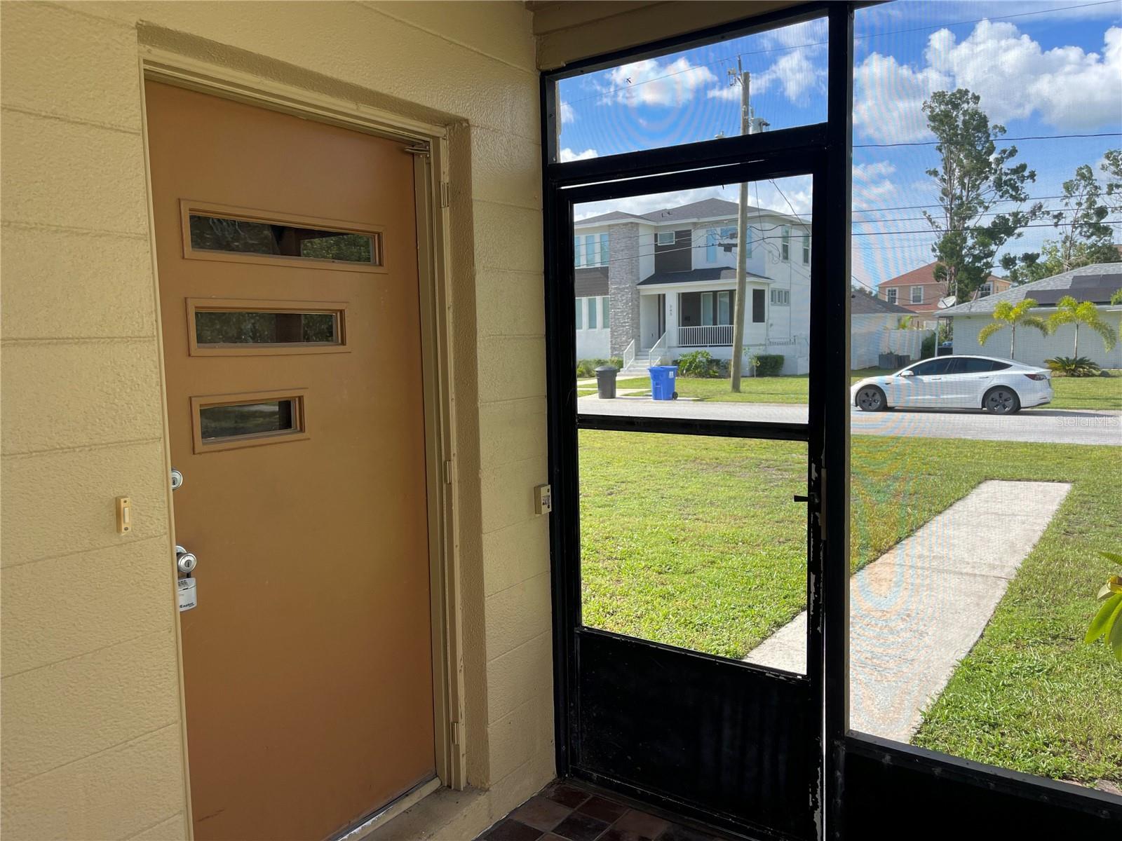 MID CENTURY FRONT DOOR + SCREENED PATIO AREA