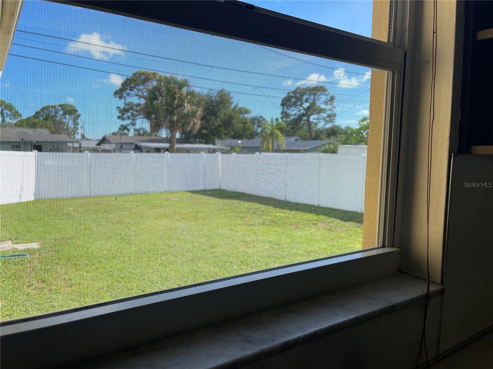 BACK YARD THRU THE KITCHEN WINDOW