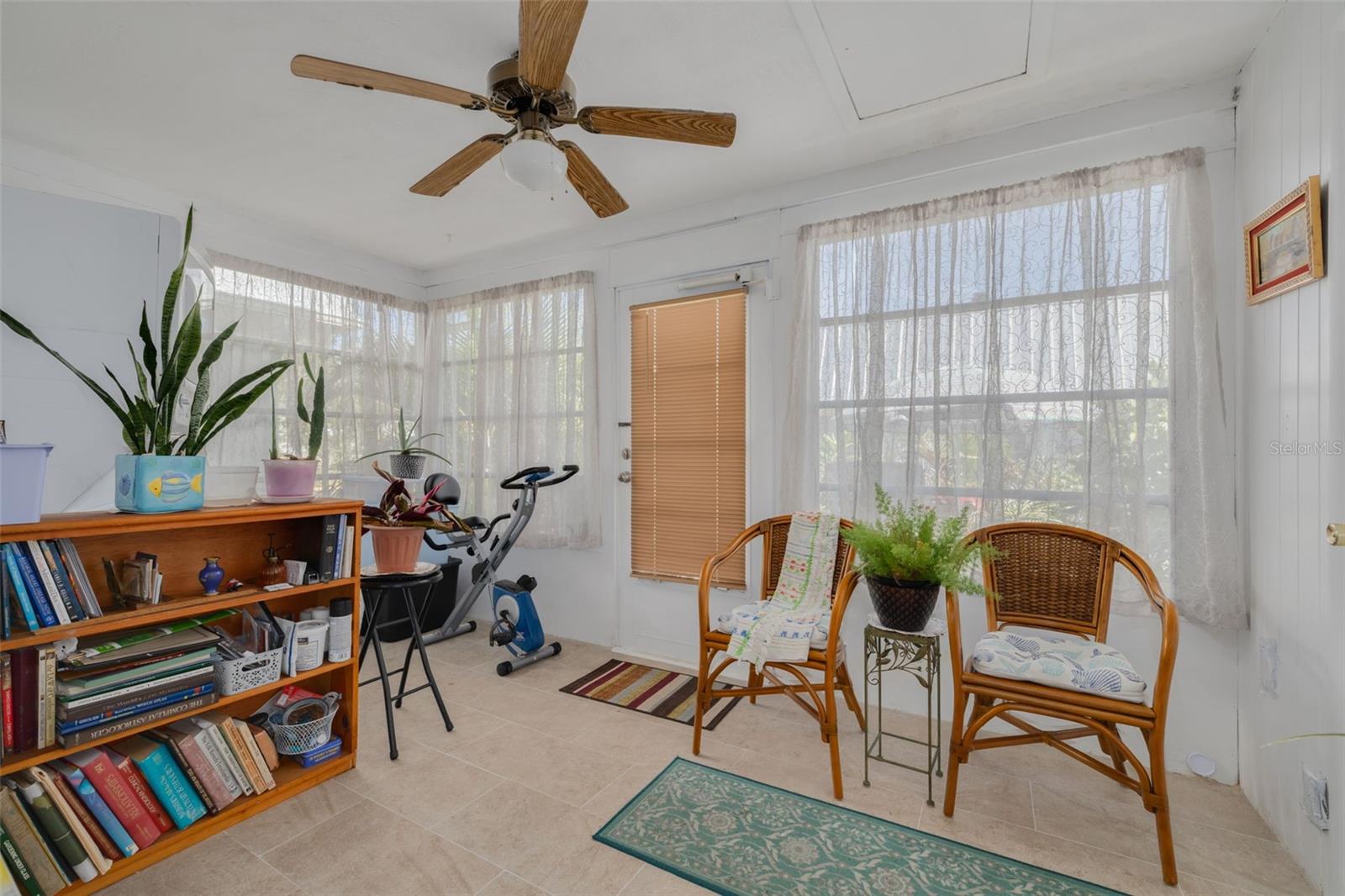 Sun Parlor overflowing with natural light, newer ceramic flooring.