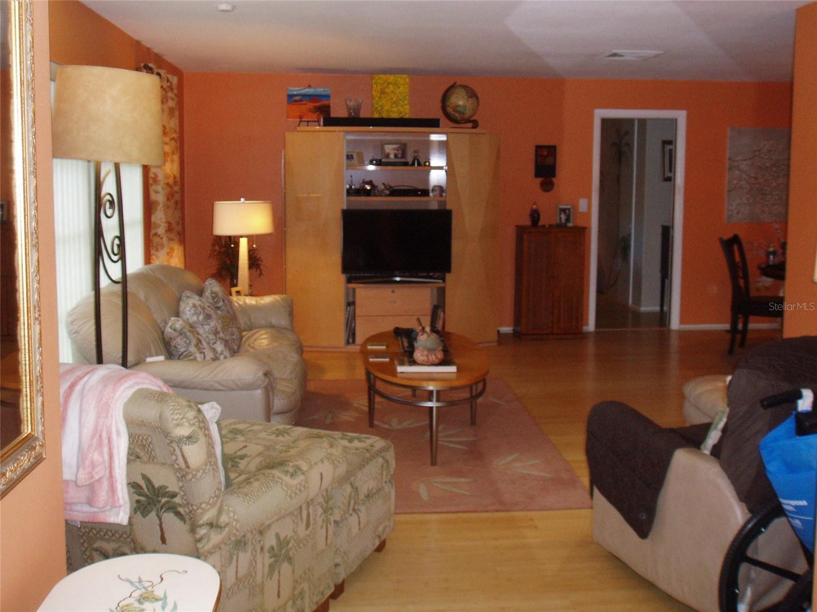 view of living room inside front door and foyer looking left to living room