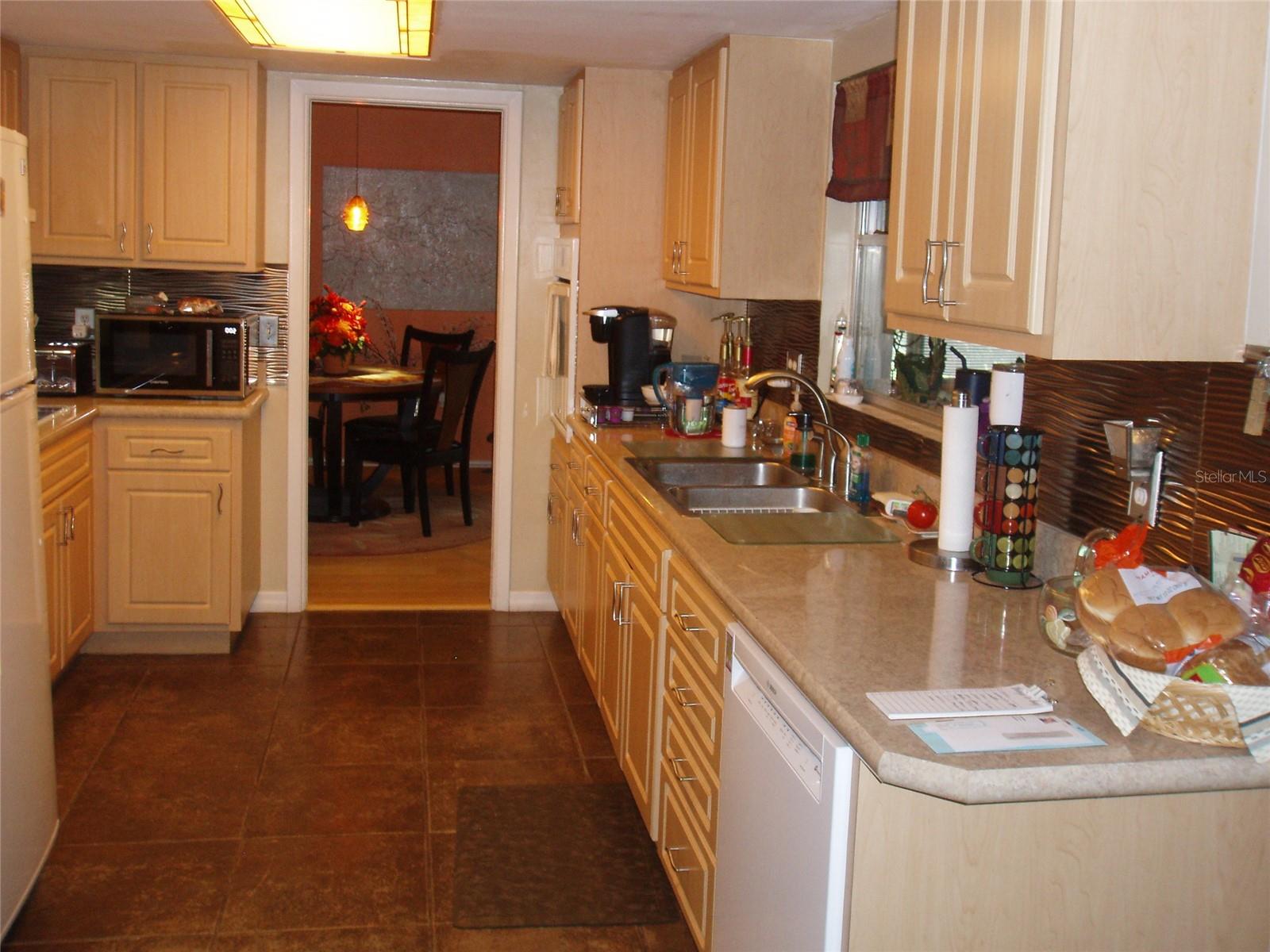 kitchen view off foyer to eating area. pocket door can be closed