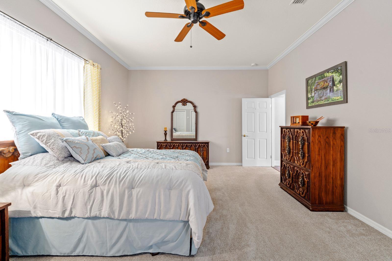 Bedroom 2 is extra large and can be used as an in-law suite since it has its OWN BATHROOM!  This bedroom features crown molding, extremely clean carpet, a lighted ceiling fan, a large amount of storage space, and a large window.