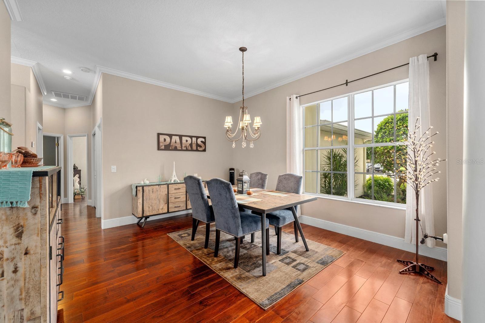 The dining room is spacious, features crown molding, 5-1/4" baseboards, and filled with natural light.